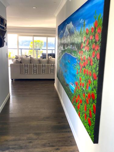 a living room with a painting on the wall at Luxury Lake House Retreat in Mangakino