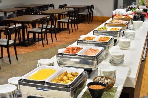 a buffet line with many trays of food at FLEXSTAY INN Hakodate Station in Hakodate