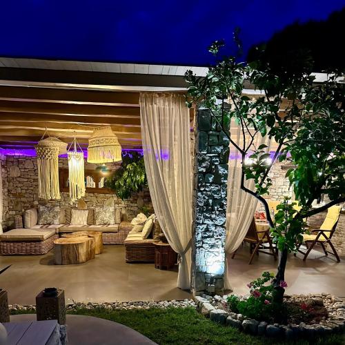 a living room with a couch and a table at Byblos Luxury Villa in Prinos