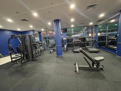 a gym with several treadmills and machines at Hotel Diana Woolloongabba in Brisbane