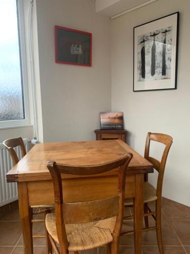 a wooden table and chairs in a room at Tournicolette - 52 m2 charme fou in Chardonne