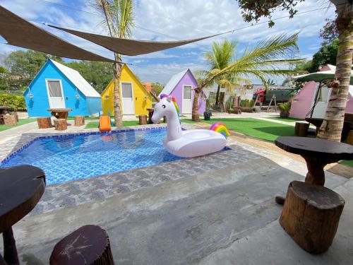 a pool with a unicorn float in a backyard at IT SWISS GARDEN in Perai