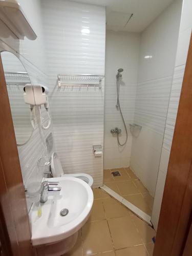 a bathroom with a toilet and a sink and a shower at Soulmate Hotel Erbil in Erbil