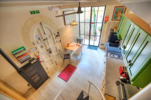 an overhead view of a living room with a table and a door at Independent Old House in Gozo With Modernized Interior in Munxar