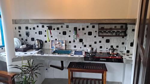 a kitchen with a counter and a stove in it at Taco Kings Place in Unawatuna