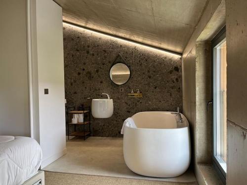 a bathroom with a large tub and a sink at Apartamento MENDEBALDE 