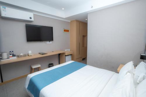 a hotel room with a bed and a flat screen tv at ARK HOTEL in Phnom Penh