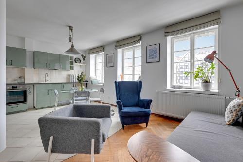 a living room with a couch and a chair at Downtown Apartments Old Town Powroźnicza in Gdańsk