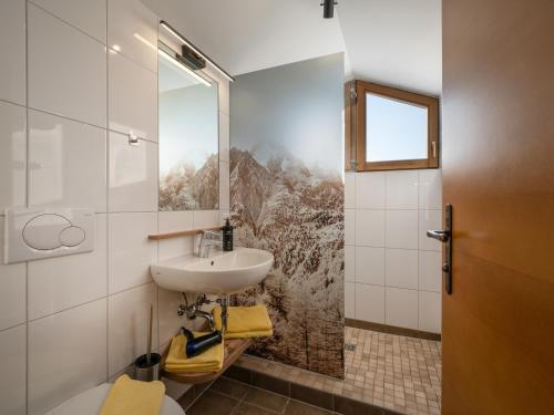 a bathroom with a sink and a mirror at Brixentalerhof in Westendorf