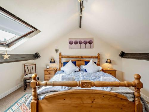 a bedroom with a wooden bed in a attic at 3 Bed in Kendal 91839 in Kendal