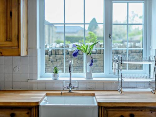a kitchen counter with a sink and a window at 5 Bed in Bingley 91977 in Bingley