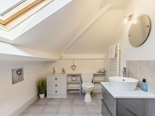 a white bathroom with a sink and a toilet at 5 Bed in Westward Ho 91772 in Bideford