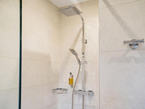 een douche met een glazen deur in de badkamer bij 3 bed property in Gower South Wales 91727 