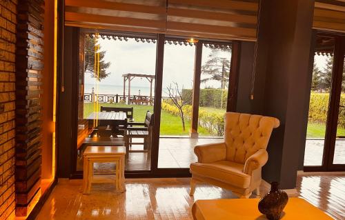 a living room with a chair and a table at LİFOZ Holiday resort in Trabzon