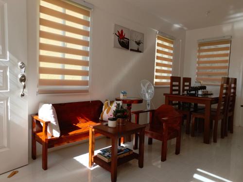 a living room with a couch and a table at Niana’s Place 2BR w Garden, Internet, Netflix in Legazpi