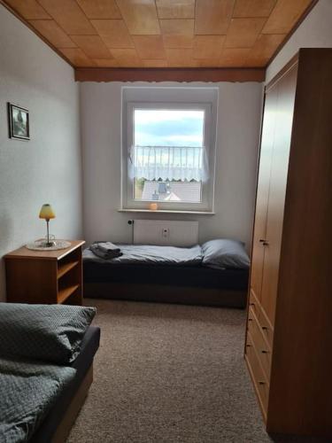 a bedroom with a bed and a window at Gästewohnung KL. WZL 33_7 in Klein Wanzleben