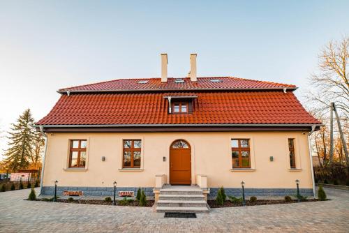 a small white house with a red roof at Villa Sophia in Biskupiec