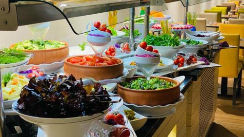 a buffet with many bowls of food on a table at Hotel Sun in Lefkosa Turk