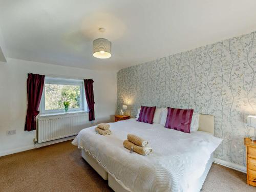 a bedroom with a bed with two teddy bears on it at 1 Bed in Matlock 91824 in Tansley
