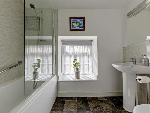 a bathroom with a sink and a window at 1 Bed in Matlock 91824 in Tansley