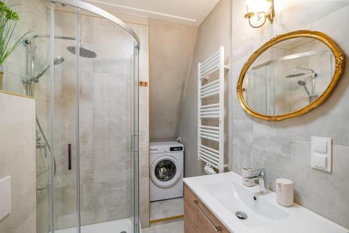 a bathroom with a sink and a washing machine at Villa Sophia in Biskupiec