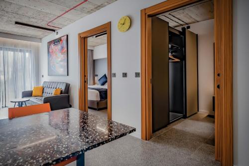 a kitchen and living room with a table in a room at Grands Suites Hotel Residences and Spa in Il-Gżira