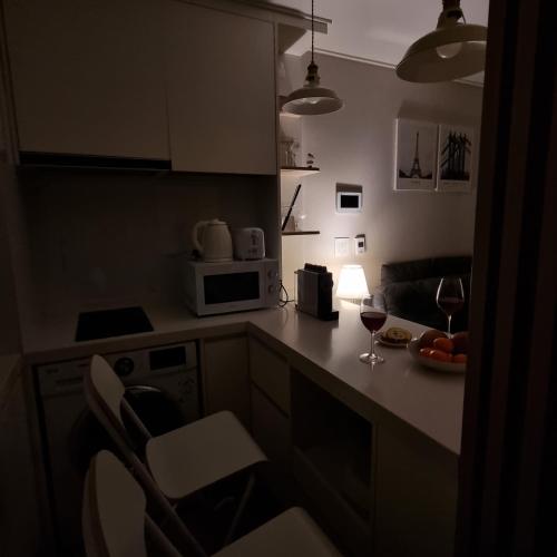a kitchen with a counter with a glass of wine at Yangyang Ocean Stay 환상적 전면 오션뷰 in Yangyang