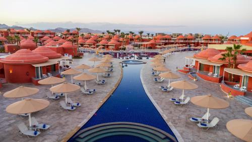 an aerial view of a resort with a pool and umbrellas at Pickalbatros Laguna Club Resort Sharm El Sheikh in Sharm El Sheikh