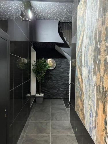 a hallway with a staircase and a tile floor at Super Appartement T2 Luxe in Frontenex-Villard-Rosset