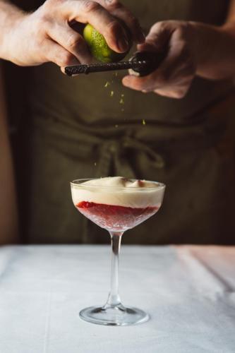a person is preparing a dessert in a martini glass at De Durgerdam, Amsterdam in Amsterdam