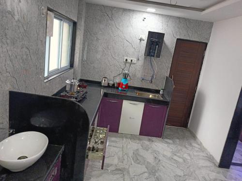 a small kitchen with a sink and a sink at Soumil 102 in Chinchwad