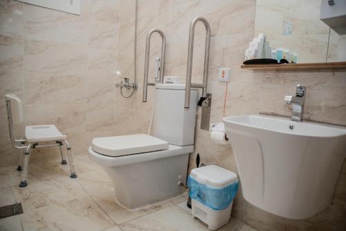 a bathroom with a toilet and a sink at Vital House Apartments شقق البيت الحيوي in Jeddah