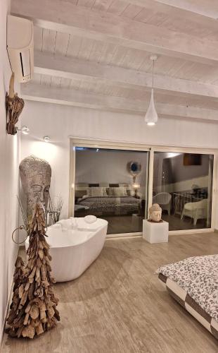 a large bathroom with a tub and a bed at VILLA G&G CALABRIA in Campora San Giovanni