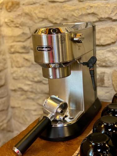 a coffee maker sitting on top of a table at Útulný dům pro odpočinek in Malotice