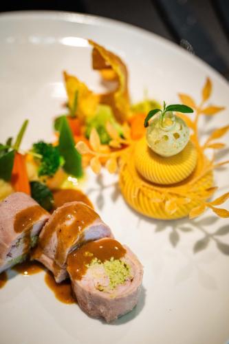 a plate of food with meat and vegetables on it at HVD Grand Hotel Suhl Business & Leisure in Suhl