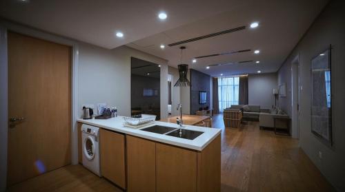 a kitchen with a sink and a washing machine at 188 suites By Seng Home in Kuala Lumpur