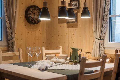 a dining room with a table with chairs and lights at Chalet Jochwand Bad Goisern - Your Austrian Home in Bad Goisern