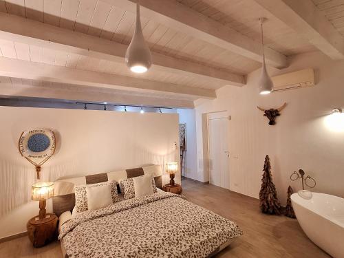 a bedroom with a bed and a tub in a room at VILLA G&G CALABRIA in Campora San Giovanni