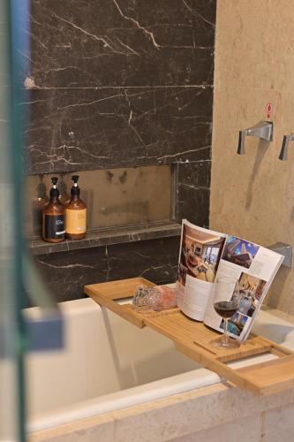 a bathroom table with a magazine and a wine glass at Snug Gaokong Jiangjing Hotel in Guangzhou