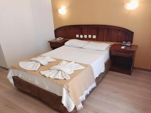 een slaapkamer met een bed met handdoeken erop bij Grand Cnr Hotels in Fethiye