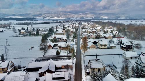 a small town covered in snow with houses at Apartament Janusza in Gronków