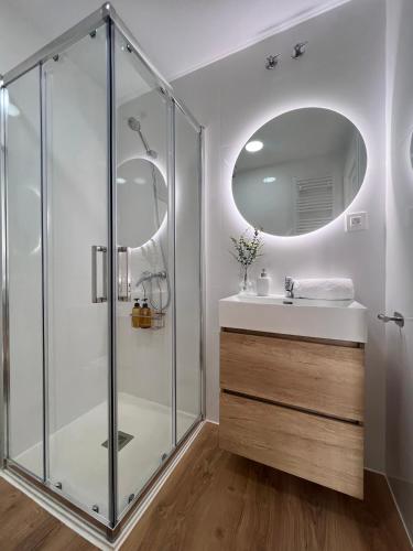 a bathroom with a glass shower and a sink at Numancia Suites in Soria