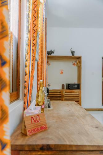 a no smoking sign on a wooden table in a room at Shoki Shoki Hotel Stone Town in Zanzibar City