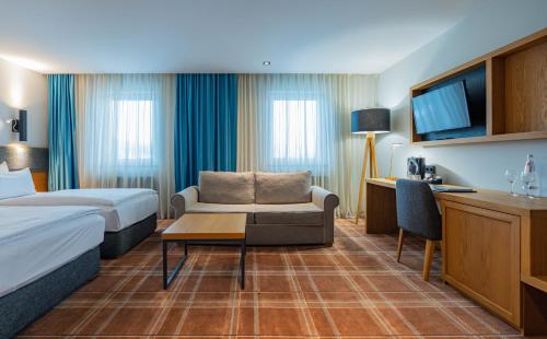 Ένα ή περισσότερα κρεβάτια σε δωμάτιο στο HVD Grand Hotel Suhl Business & Leisure