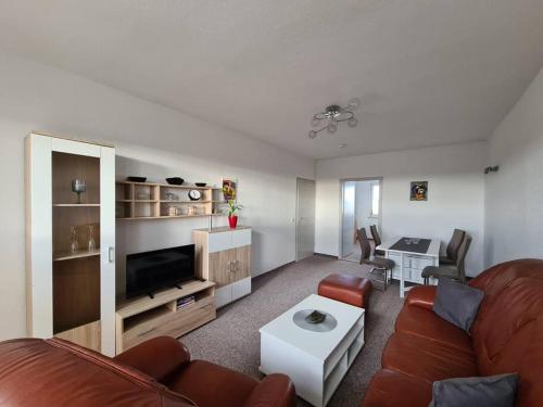 a living room with a couch and a table at Gästewohnung KL. WZL 30_5 in Klein Wanzleben