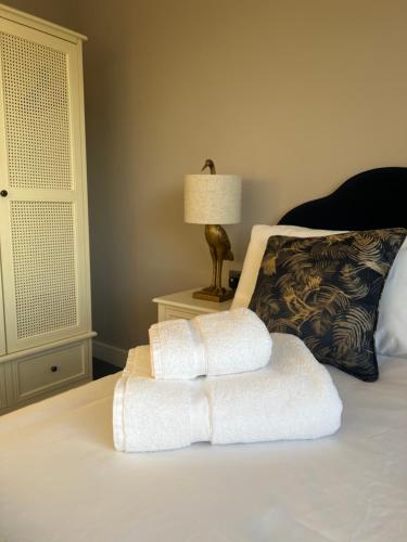 a bedroom with a bed with two towels on it at Brian’s Escape in Great Driffield