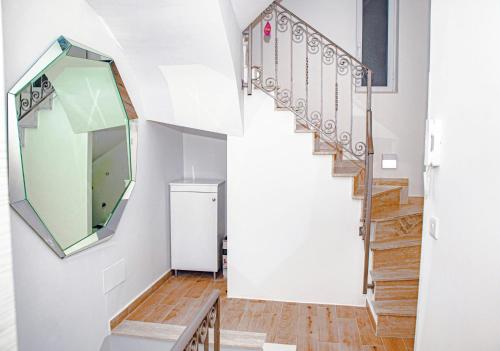 a hallway with stairs and a mirror on the wall at Sunny House Apartment 44 Malta in Taʼ Xbiex