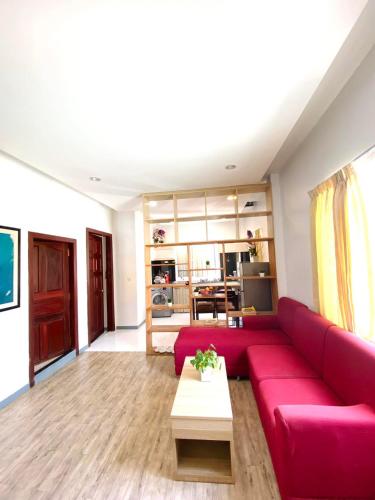 a living room with a red couch and a table at White Residence Hotel & Apartment in Phnom Penh