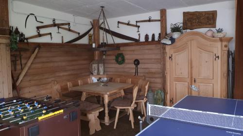 a dining room with a table and a ping pong table sidx sidx at Plattenberger Hof in Waging am See