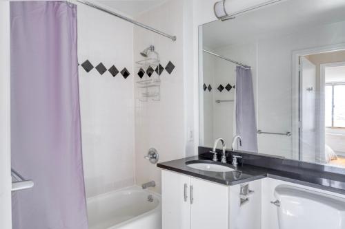 a white bathroom with a sink and a tub at UWS 1br w gym doorman elevator nr Central Park NYC-1048 in New York